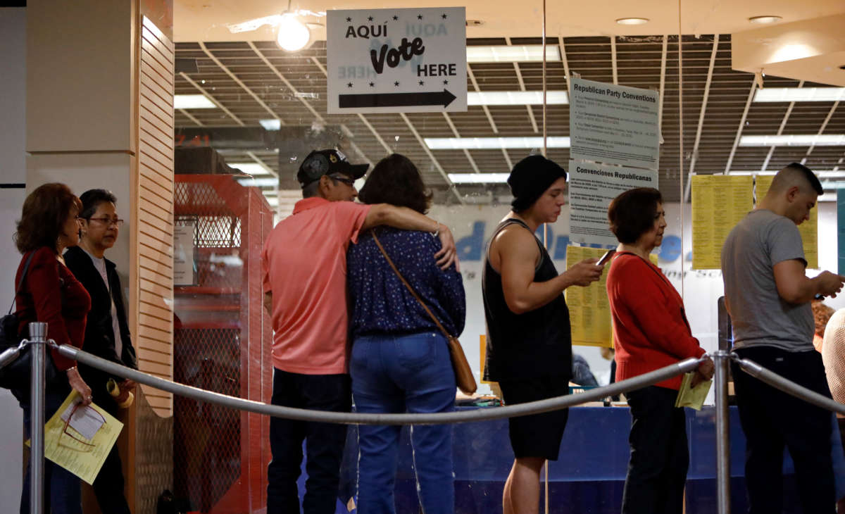 Voters wait in line to cast their ballots on March 3, 2020, in San Antonio, Texas.