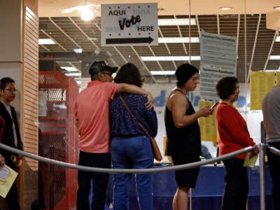 Voters wait in line to cast their ballots on March 3, 2020, in San Antonio, Texas.