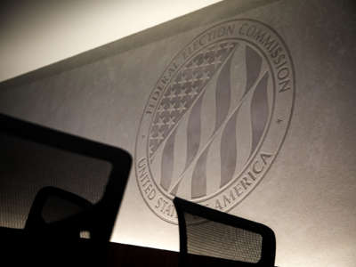 The seal of the Federal Election Commission is engraved into a stone wall inside its headquarters