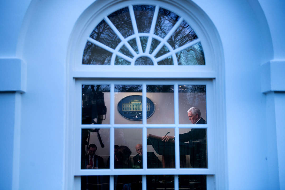 Mike Pence is seen speaking to reporters through a white house window