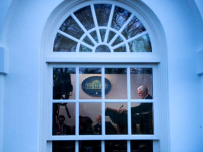 Mike Pence is seen speaking to reporters through a white house window