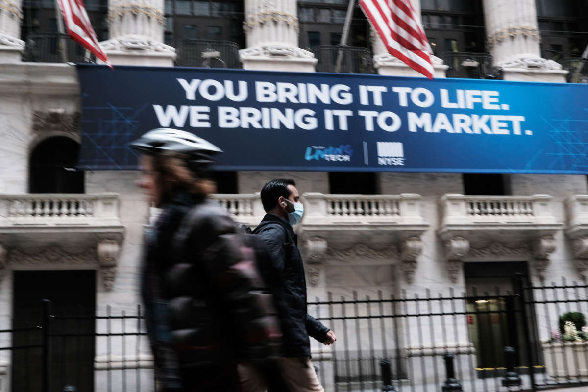 A man in a medical mask walks by the New York Stock Exchange on March 10, 2020, in New York City.