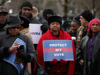 Residents from Alabama stand in line outside the U.S. Supreme Court for a chance to hear oral arguments in a legal challenge to Section 5 of the Voting Rights Act on February 27, 2013, in Washington, D.C.