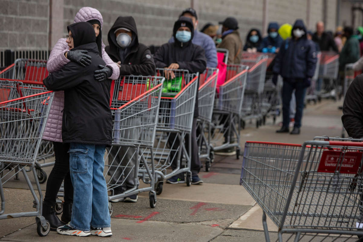 Customers line up to shop at a Costco store in Brooklyn as the COVID-19 outbreak continues on March 19, 2020, in New York City.