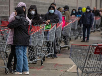 Customers line up to shop at a Costco store in Brooklyn as the COVID-19 outbreak continues on March 19, 2020, in New York City.