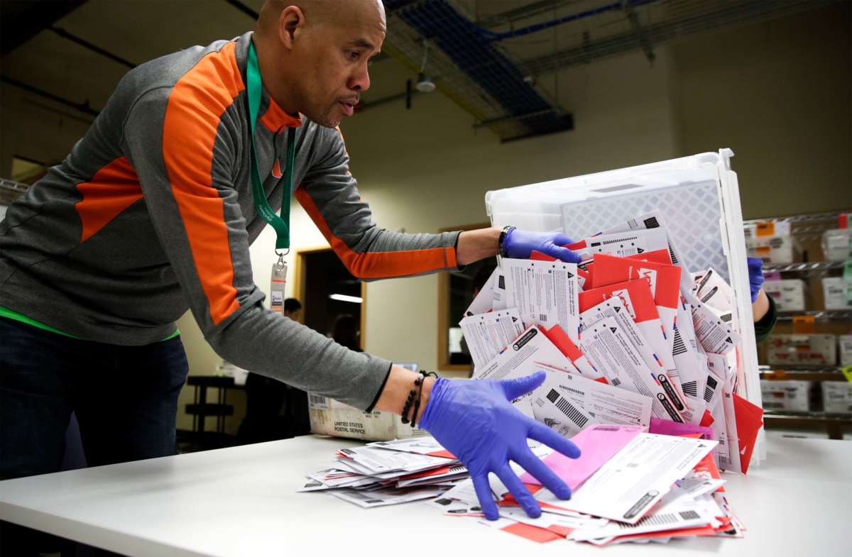 Election worker Erick Moss sorts vote-by-mail ballots for the presidential primary at King County Elections in Renton, Washington, on March 10, 2020.