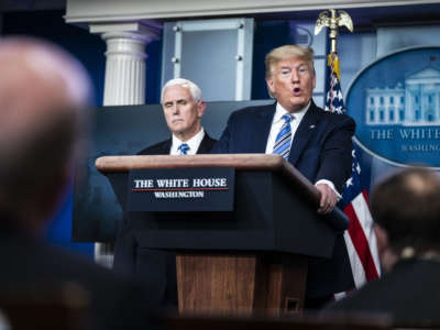 Donald Trump makes a face while standing at a podium