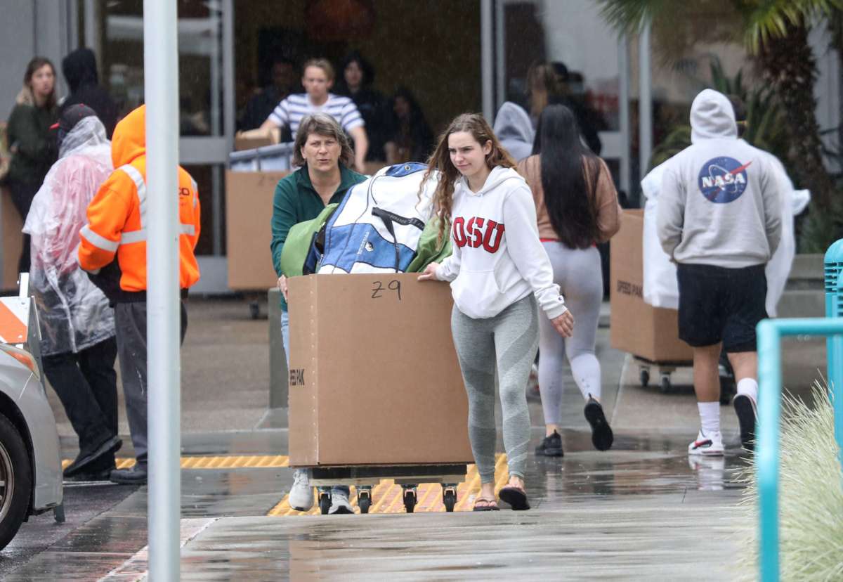 Students and their parents move their belongings from their dormitories at San Diego State University in San Diego, California, on March 18, 2020.