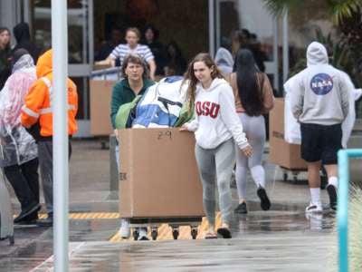 Students and their parents move their belongings from their dormitories at San Diego State University in San Diego, California, on March 18, 2020.
