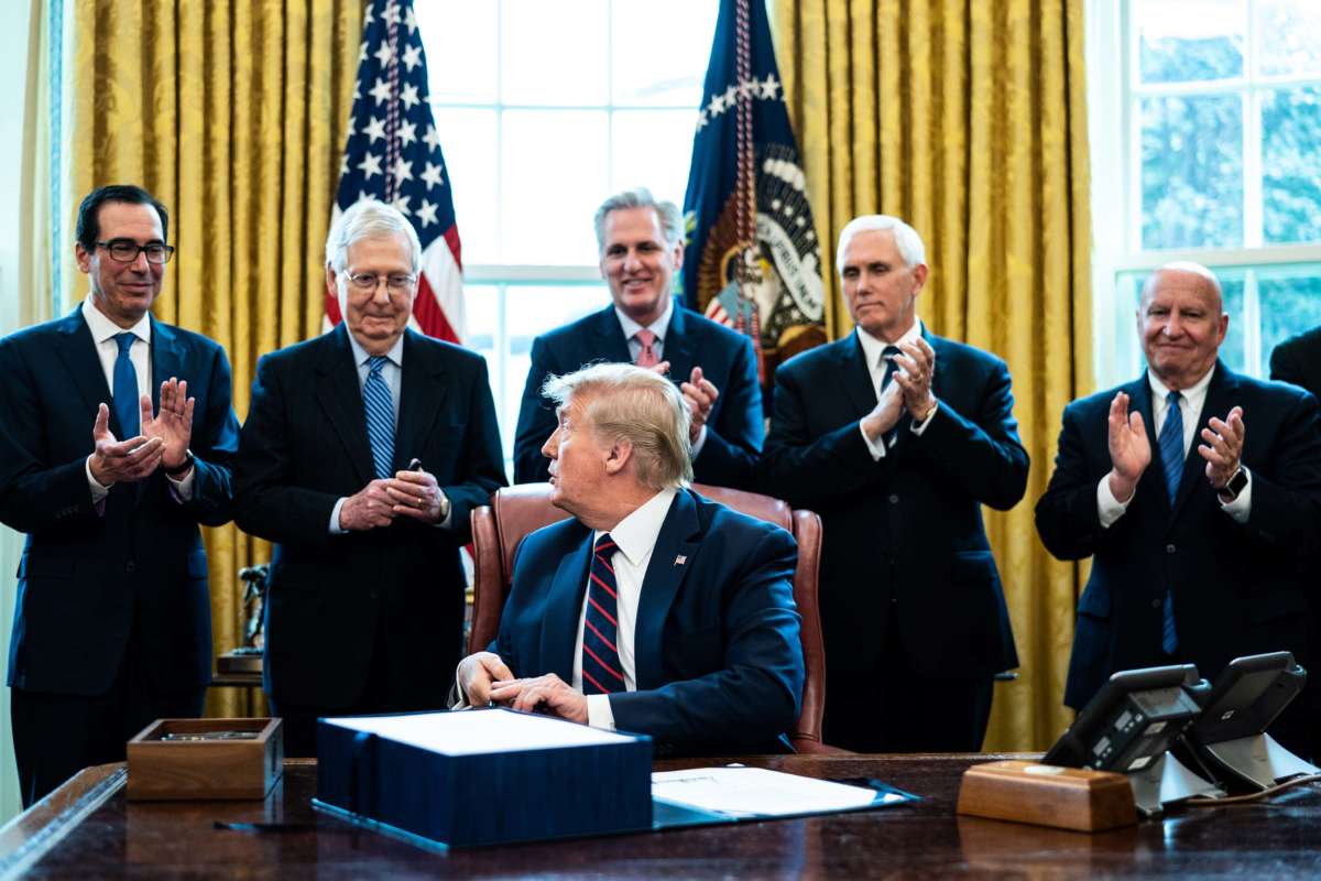 (L-R) Treasury Secretary Steven Mnuchin, Senate Majority Leader Mitch McConnell, House Minority Leader Kevin McCarthy, Vice President Mike Pence and Rep. Kevin Brady applaud President Trump during a bill signing ceremony for H.R. 748, the CARES Act, in the Oval Office of the White House on March 27, 2020, in Washington, D.C.