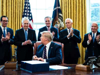 (L-R) Treasury Secretary Steven Mnuchin, Senate Majority Leader Mitch McConnell, House Minority Leader Kevin McCarthy, Vice President Mike Pence and Rep. Kevin Brady applaud President Trump during a bill signing ceremony for H.R. 748, the CARES Act, in the Oval Office of the White House on March 27, 2020, in Washington, D.C.