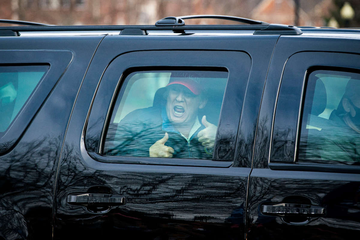 President Trump gives a thumbs up towards supporters as he departs Trump National Golf Club on December 13, 2020, in Sterling, Virginia.
