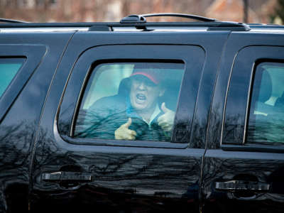 President Trump gives a thumbs up towards supporters as he departs Trump National Golf Club on December 13, 2020, in Sterling, Virginia.
