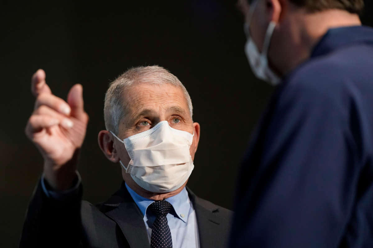 Dr. Anthony Fauci, director of the National Institute of Allergy and Infectious Diseases, speaks with Health and Human Services Secretary Alex Azar before receiving his first dose of the COVID-19 vaccine at the National Institutes of Health on December 22, 2020, in Bethesda, Maryland.