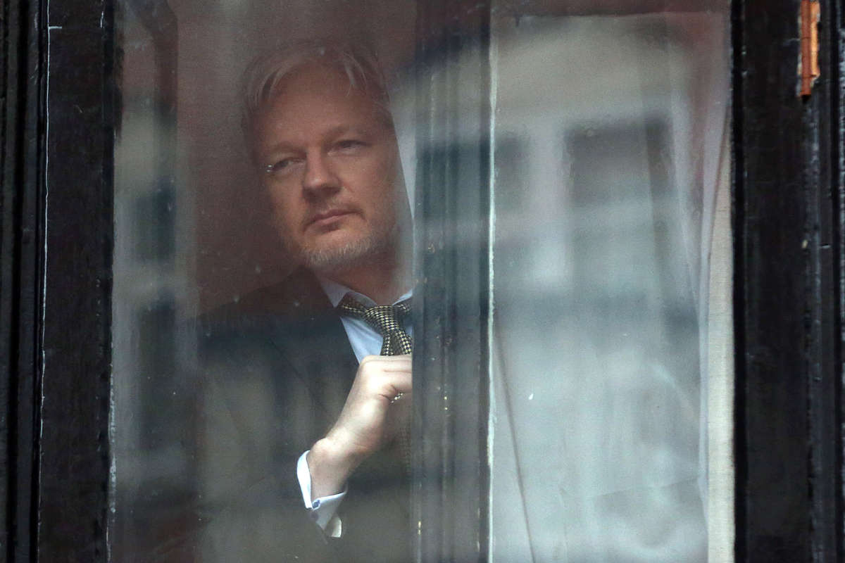 Wikileaks founder Julian Assange prepares to speak from the balcony of the Ecuadorian embassy on February 5, 2016, in London, England.