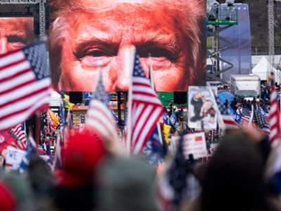 An image of President Trump appears on video screens before his speech to supporters from The Ellipse at the White House in Washington, D.C., on January 6, 2021.