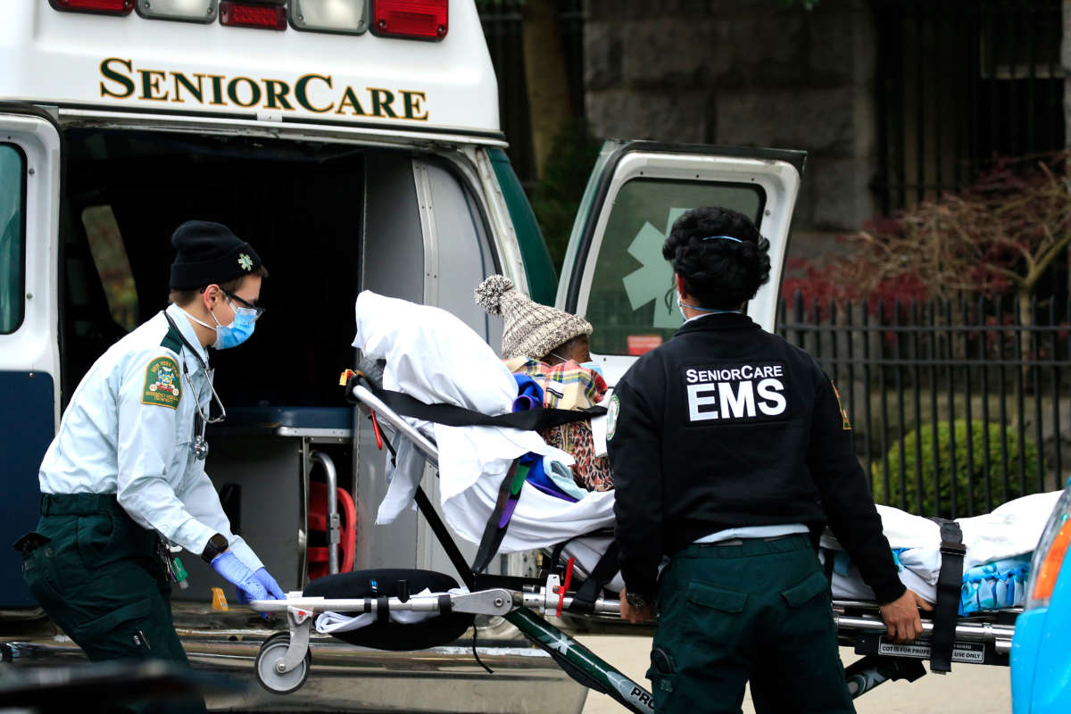 Emergency Medical Service workers unload a patient out of their ambulance at the Cobble Hill Health Center on April 18, 2020, in the Cobble Hill neighborhood of the Brooklyn borough of New York City.