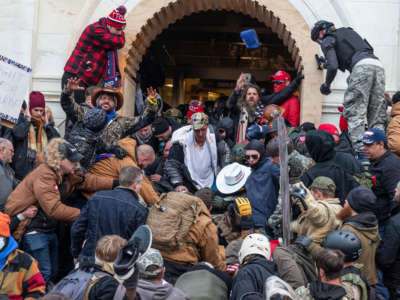 Trump loyalists clash with police trying to enter Capitol building through the front doors. Rioters broke windows and breached the Capitol building in an attempt to overthrow the results of the 2020 election.