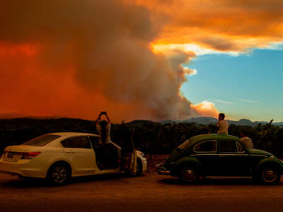 People watch the Walbridge fire, part of the larger LNU Lightning Complex fire, from a vineyard in Healdsburg, California on August 20, 2020.