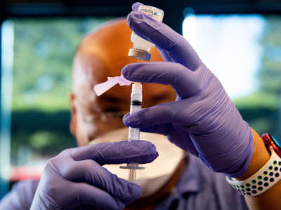 UC Berkeley University Health Services pharmacy director Efren Bose prepares a dose of the Moderna COVID-19 vaccine before administering it at Tang Center near UC Berkeley in Berkeley, California, on January 14, 2021.