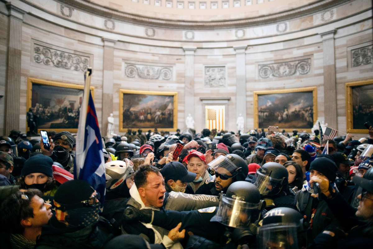 Police clash with Trump loyalists who breached security and entered the Capitol building in Washington D.C. on January 6, 2021.