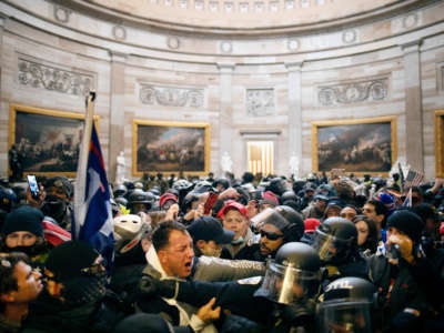 Police clash with Trump loyalists who breached security and entered the Capitol building in Washington D.C. on January 6, 2021.