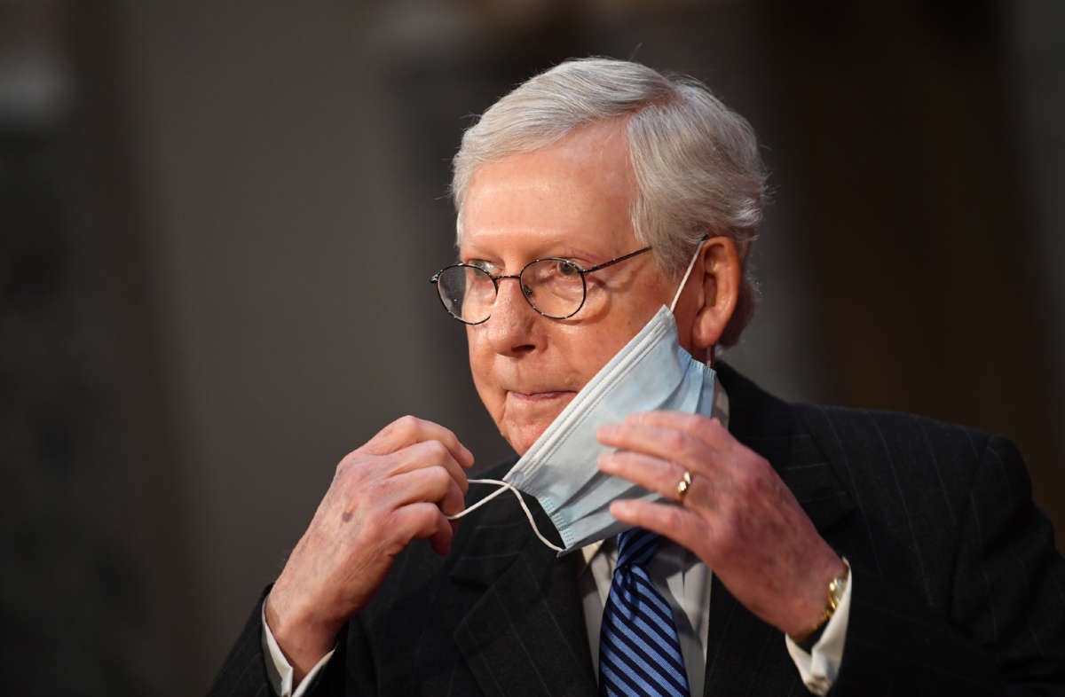 Senate Majority Leader Mitch McConnell adjusts his face mask at the U.S. Capitol Building on January 3, 2021, in Washington, D.C.