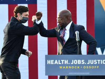 Georgia Democratic Senate candidates Jon Ossoff and Raphael Warnock greet each other onstage during a "Vote GA Blue" concert at New Birth Church on December 28, 2020, at New Birth Church in Stonecrest, Georgia.