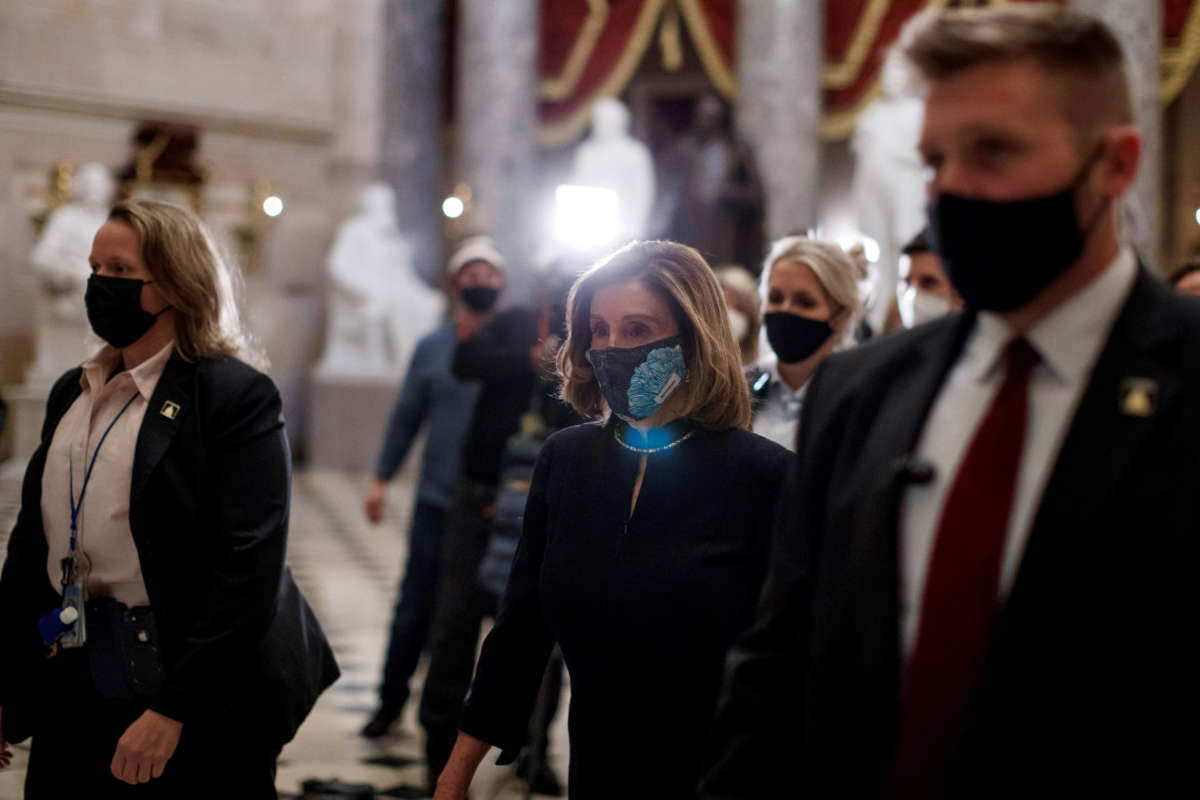 House Speaker Nancy Pelosi wears a protective mask as she walks through the Capitol Building in Washington, D.C. on January 13, 2021.