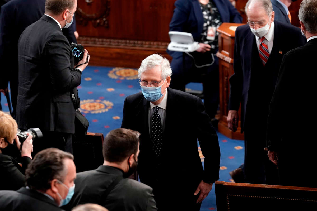 Then-Senate Majority Leader Mitch McConnell leaves the House chamber at the U.S. Capitol in Washington, D.C., January 6, 2021.