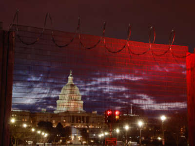 Razor wire and fences surround the U.S. Capitol building at sunrise a few days after the inauguration of President Joe Biden and Vice President Kamala Harris, on January 23, 2021.