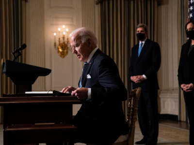 President Joe Biden prepares to sign executive orders after speaking about climate change issues in the State Dining Room of the White House on January 27, 2021, in Washington, D.C.