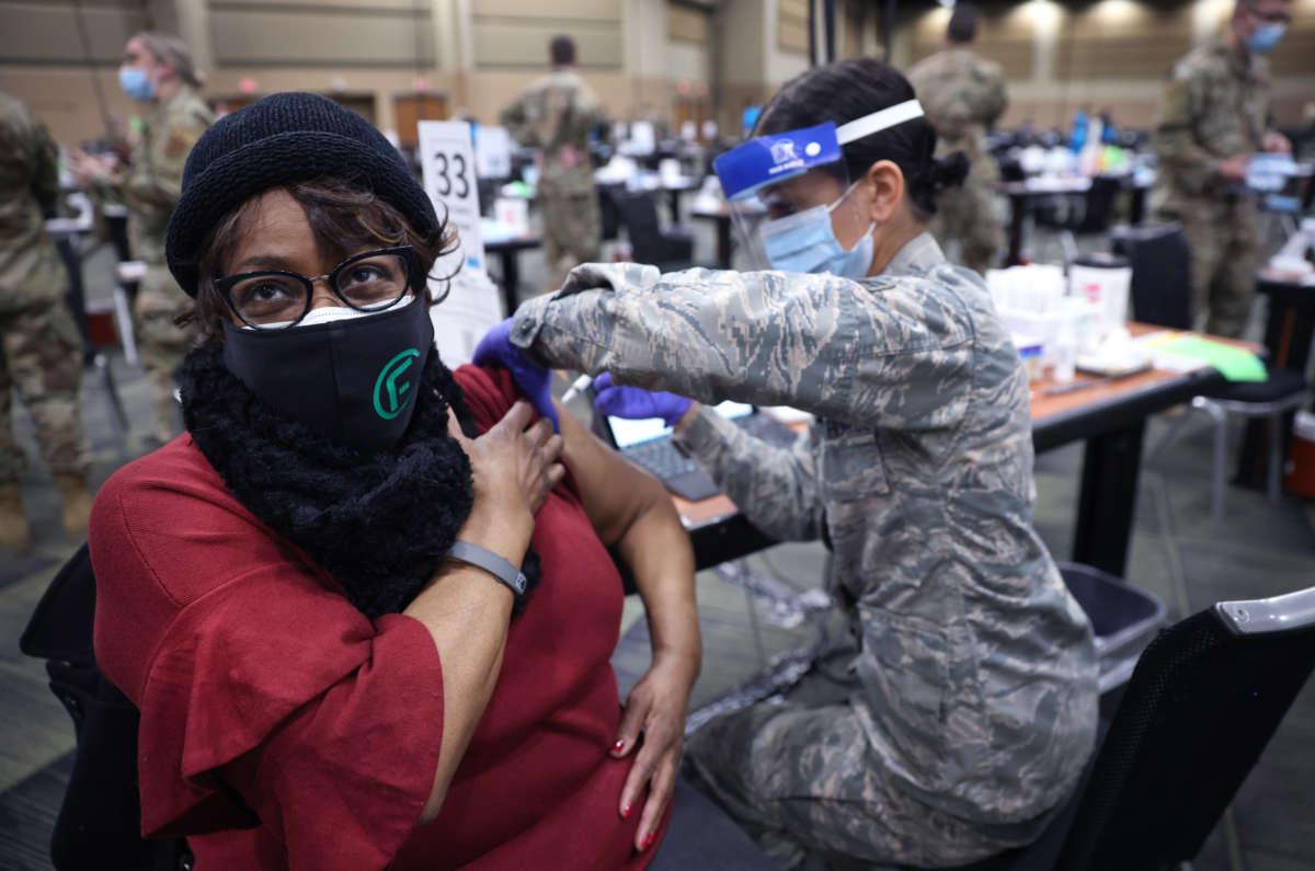 A member of the Illinois Air National Guard administers a COVID-19 vaccine at a mass vaccination center established at the Tinley Park Convention Center on January 26, 2021, in Tinley Park, Illinois.