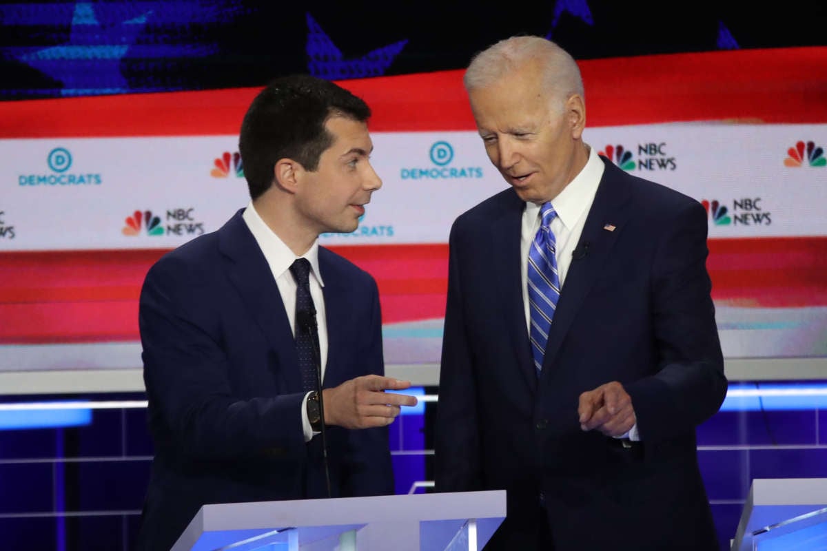 South Bend, Indiana, Mayor Pete Buttigieg and former Vice President Joe Biden talk during the second night of the first Democratic presidential debate on June 27, 2019, in Miami, Florida.