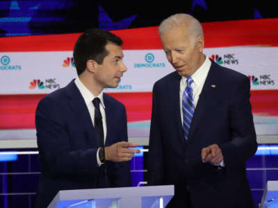 South Bend, Indiana, Mayor Pete Buttigieg and former Vice President Joe Biden talk during the second night of the first Democratic presidential debate on June 27, 2019, in Miami, Florida.