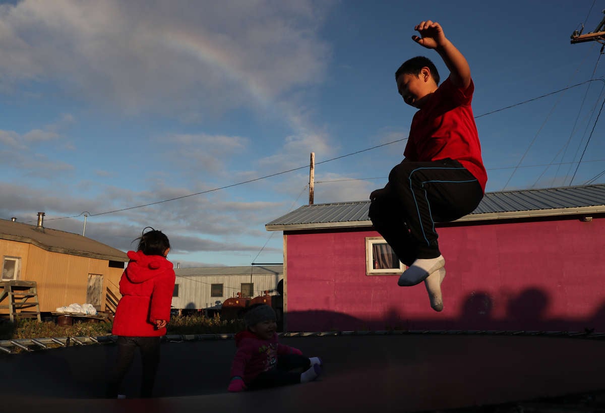 A child plays on a trampoline on September 10, 2019, in Kivalina, Alaska. Kivalina is situated at the very end of an eight-mile barrier reef located between a lagoon and the Chukchi Sea. The village is 83 miles above the Arctic circle.