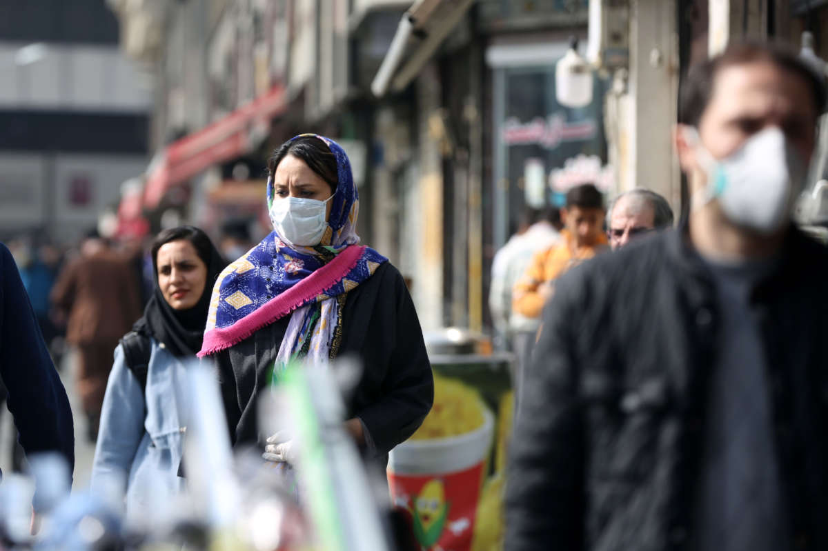 Pedestrians wear medical masks as a precaution against coronavirus (COVID-19) on March 1, 2020 in Tehran, Iran.