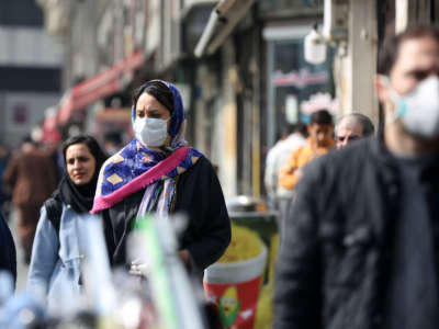 Pedestrians wear medical masks as a precaution against coronavirus (COVID-19) on March 1, 2020 in Tehran, Iran.
