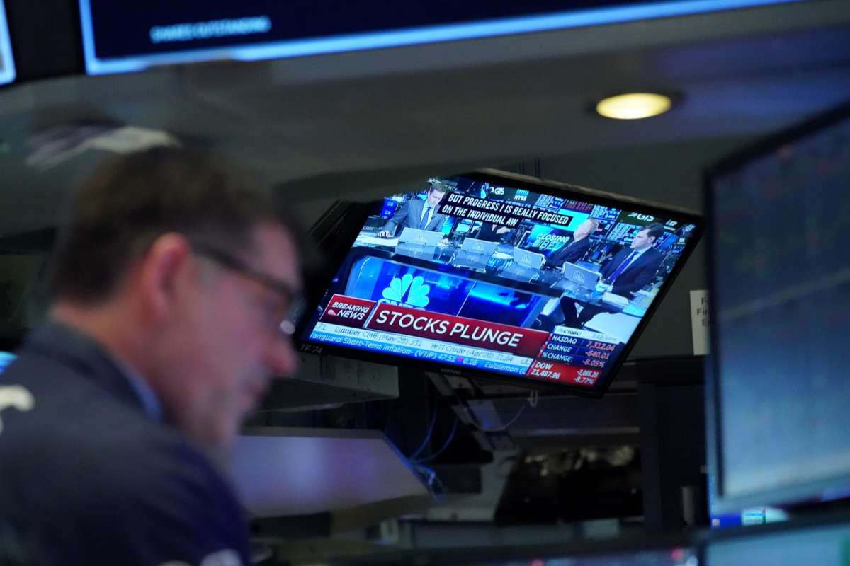 Traders work on the floor at the closing bell of the Dow Industrial Average at the New York Stock Exchange on March 12, 2020, in New York.