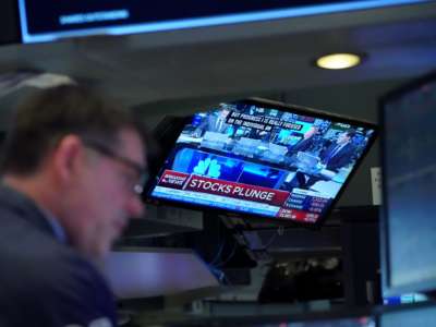 Traders work on the floor at the closing bell of the Dow Industrial Average at the New York Stock Exchange on March 12, 2020, in New York.