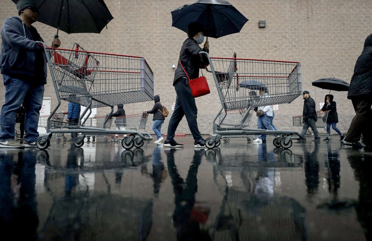 People wait in line to enter a Costco Wholesale store on March 14, 2020, in Glendale, California.