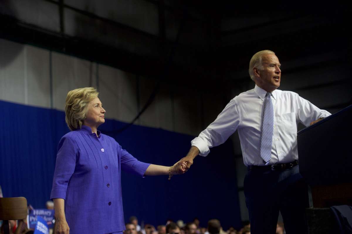 Hillary Clinton and former Vice President Joe Biden acknowledge the crowd at Riverfront Sports athletic facility on August 15, 2016, in Scranton, Pennsylvania.