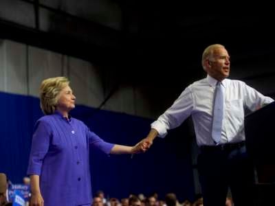 Hillary Clinton and former Vice President Joe Biden acknowledge the crowd at Riverfront Sports athletic facility on August 15, 2016, in Scranton, Pennsylvania.