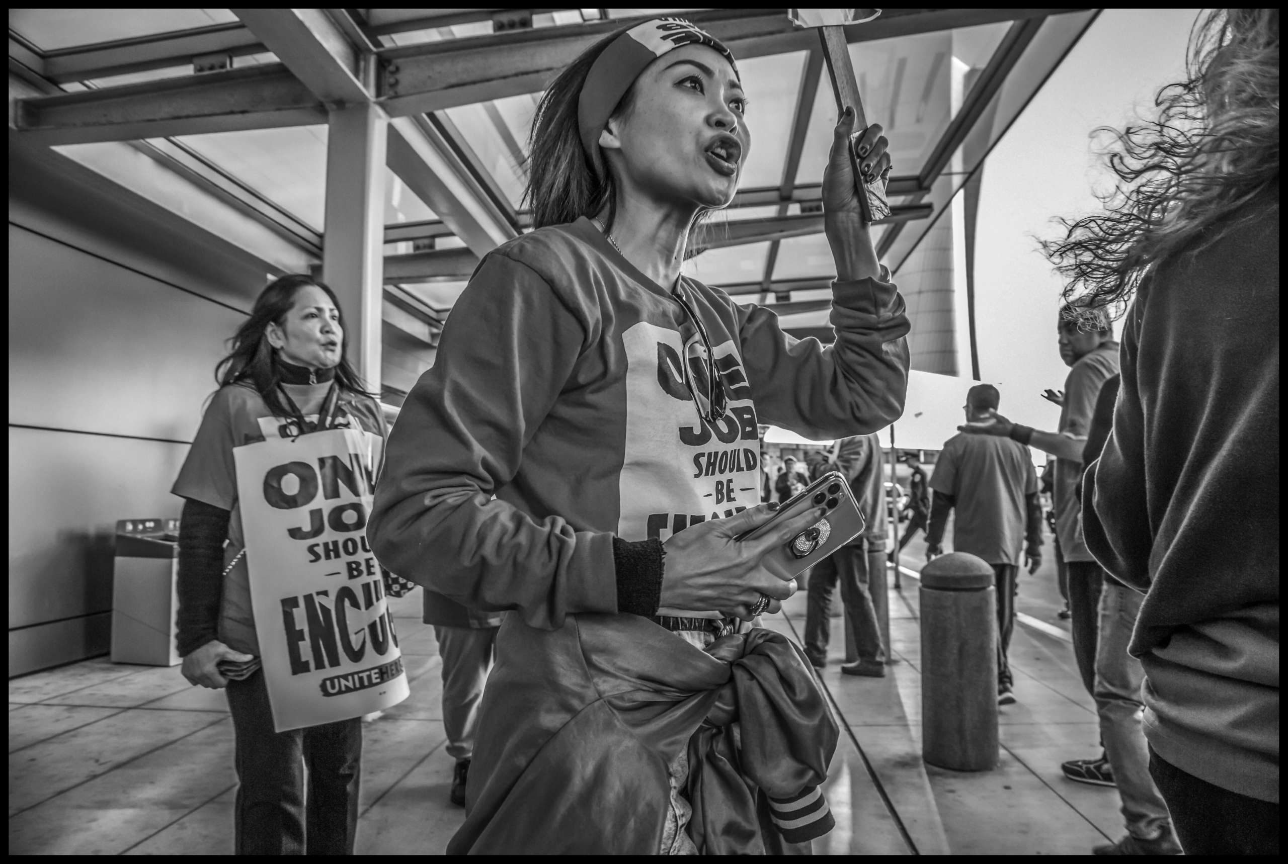 After the arrests and civil disobedience, airline kitchen workers continue to picket outside the terminal.