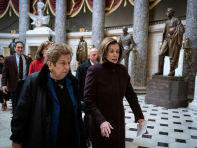 Nancy Pelosi and Donna Shalala walk in the US Capitol building