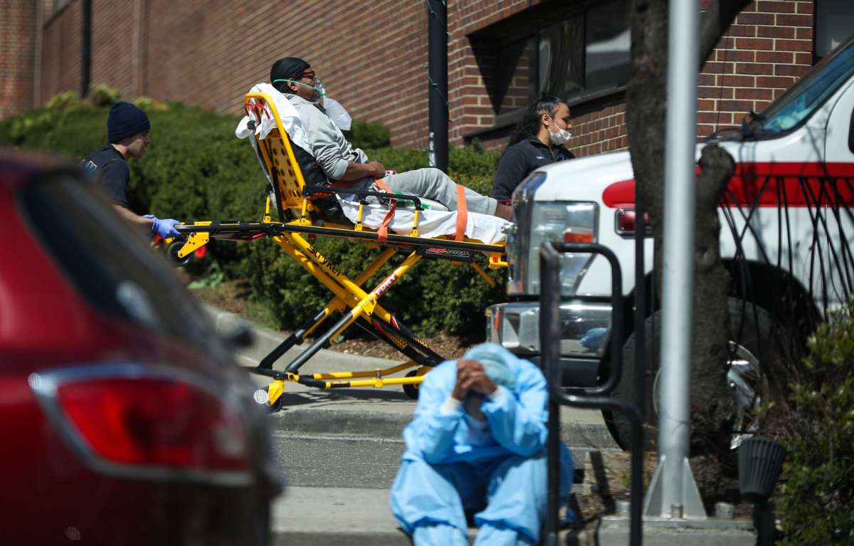 A tired healthcare worker is seen by the Brooklyn Hospital Center in New York, April 1, 2020.