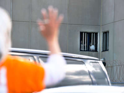 A women waves to detainees at the Strafford County Detention Center where ICE detainees are being held in Dover, New Hampshire, on August 24, 2019.