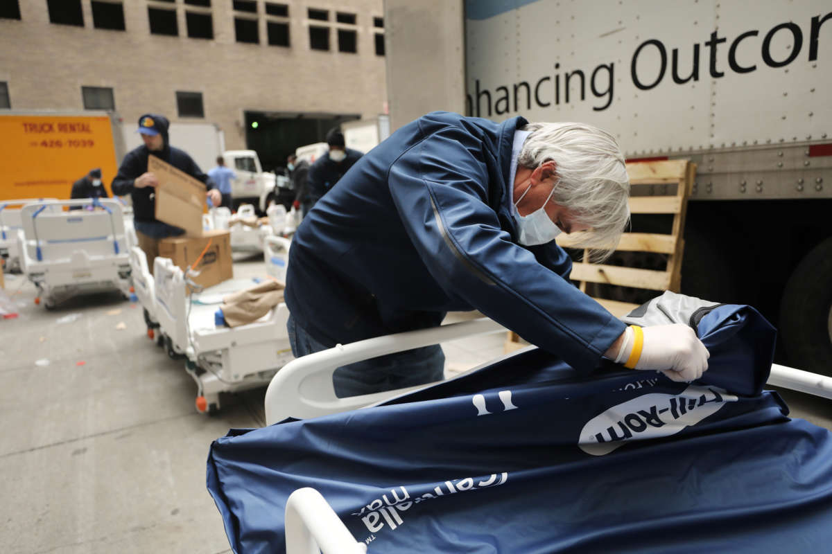 Workers prepare dozens of extra medical beds as they are delivered to Mount Sinai Hospital amid the coronavirus pandemic on March 31, 2020, in New York City.