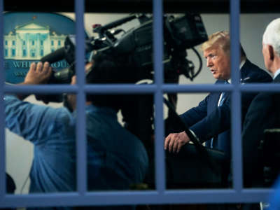 Donald Trump is seen speaking at a podium in the white house