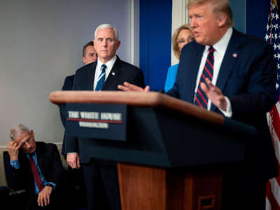 Director of the National Institute of Allergy and Infectious Diseases Dr. Anthony Fauci scratches his head and Vice President Pence looks on as President Trump speaks during the daily briefing on the novel coronavirus, COVID-19, in the Brady Briefing Room at the White House on March 27, 2020, in Washington, D.C.